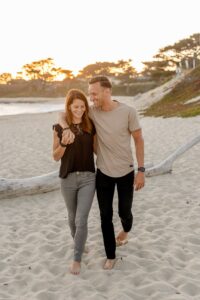 man and woman standing on beach during daytime