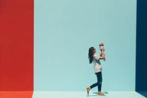 woman carrying baby while walking